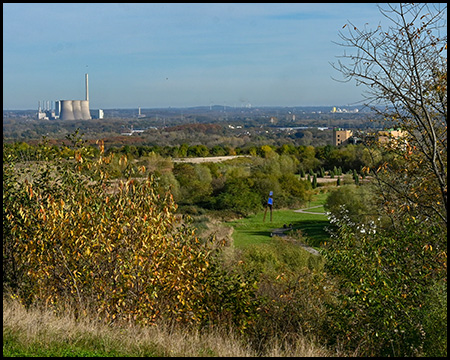 Herbstliche Landschaft mit Parkanlage und Kraftwerks-Kühltürmen am Horizont