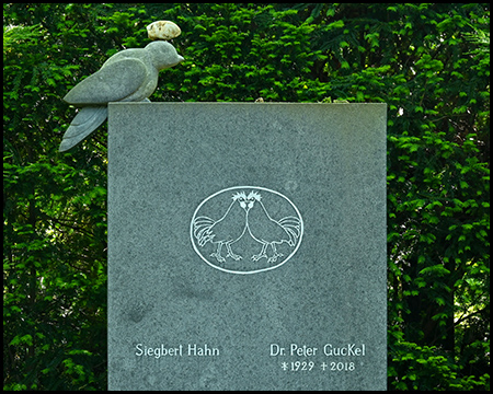 Ein spezieller Grabstein mit einer Taube und einem Stein auf ihrem Kopf